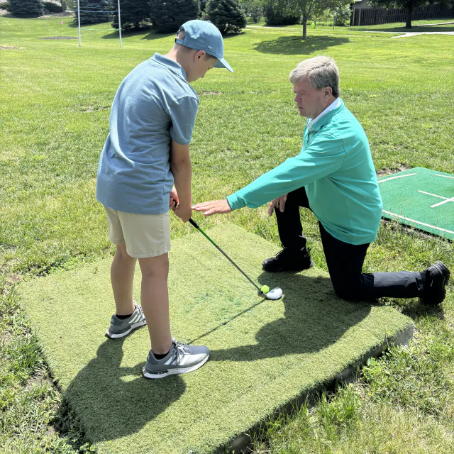 Dave Malone coaching a junior golfer at Pine Lake Junior Golf Academy
