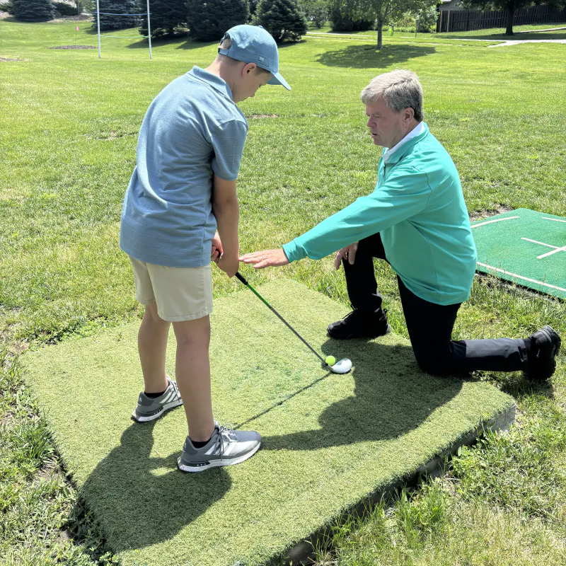 Pine Lake Junior Golf Academy coach with junior golfer