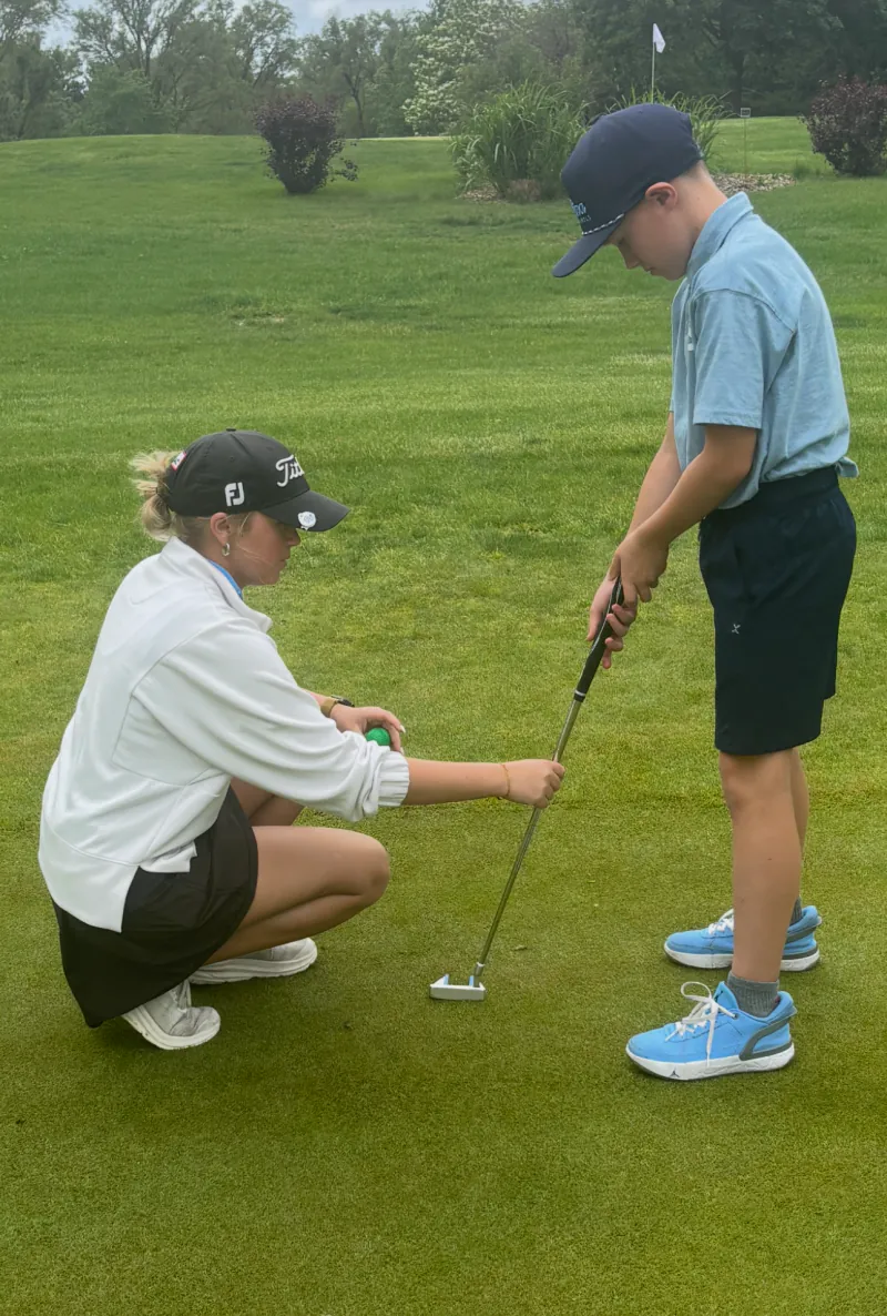 Pine Lake Junior Golf Academy coach working with junior golfer