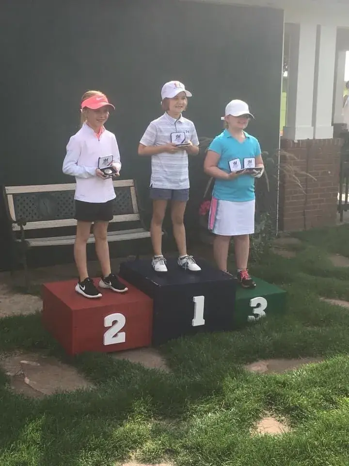 Pine Lake Junior Golf Academy golfers at an awards podium